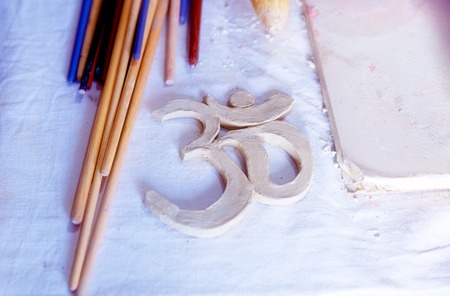 Symbol OM with clay on the desk.の写真素材