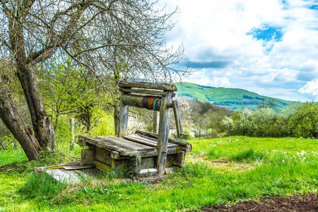 old abandoned wooden well with beautiful structure on countryside.の写真素材