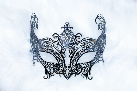 beautiful decorative venice style mask with filigrane linear ornaments on fur background.の写真素材
