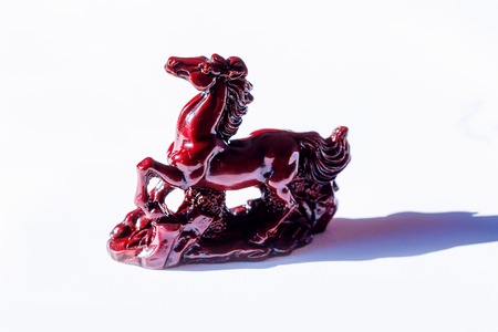 little ceramic statues of symbolic animals on white background, Horse sculptureの写真素材