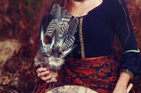 Shaman woman and shamanic feathers on denimの写真素材