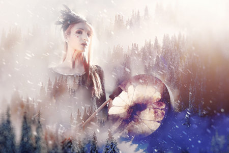 Shaman woman in winter landscape, artist collage.