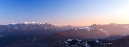 Beautiful mountain snowy landscape. Beautiful sunny day in the mountains and computer painting effectの写真素材