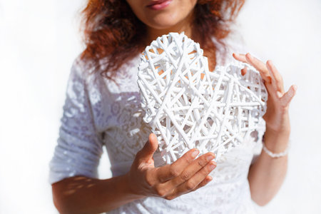 Woman and white heart in your hand.
