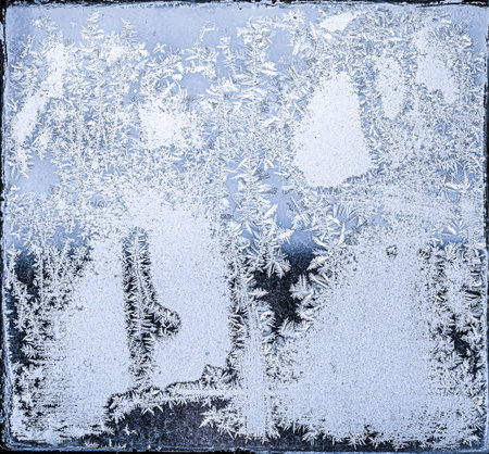 Frosty natural pattern on winter window, ornamental frost on the glass.