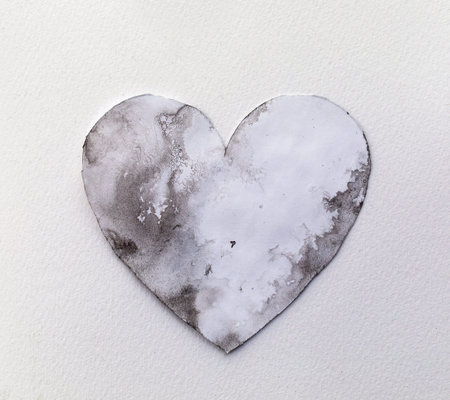 Watercolour splashes heart on white paper background.の写真素材