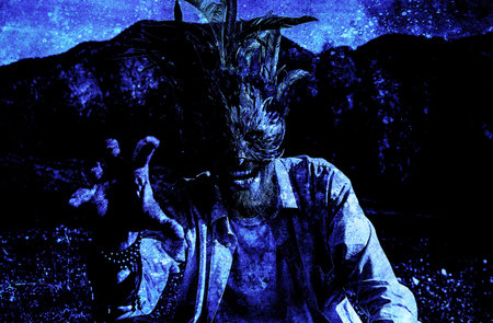 Wild man with a colorful feather face mask, old photo effect.