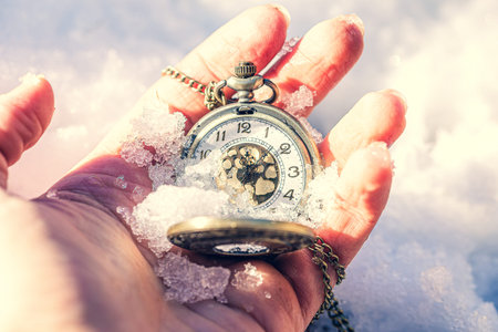 Historic watch in hand, winter background
