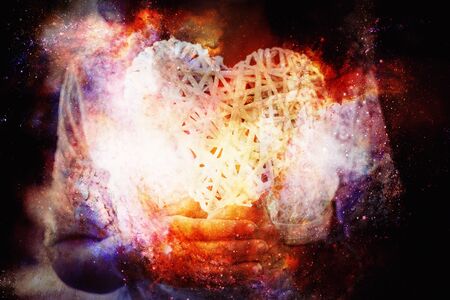 Woman and white heart in your hand on abstract structured space backgroundの写真素材