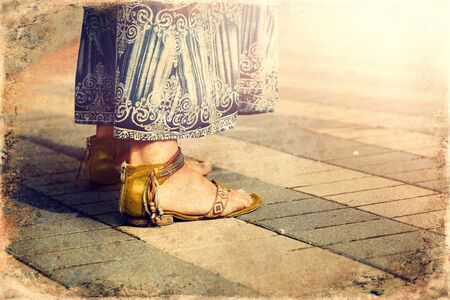 Woman stands in sandals on the road, detailの写真素材