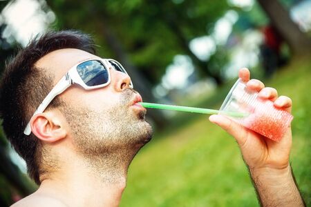 man with juice in his hand.の写真素材