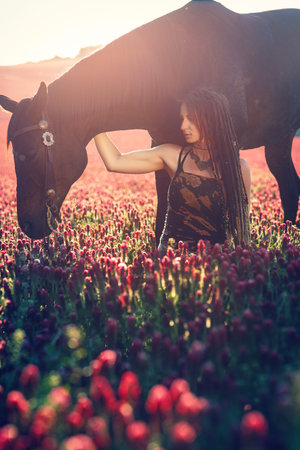 Portrait woman and horse outdoors. Woman hugging a horse.の写真素材