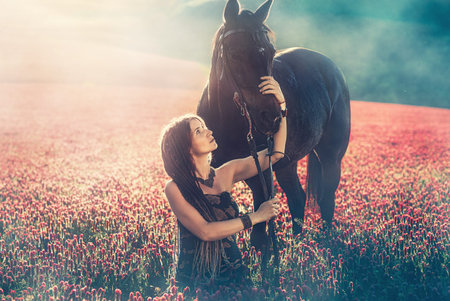 Portrait woman and horse outdoors. Woman hugging a horse.の写真素材