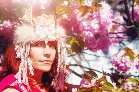 beautiful shamanic woman with headband in the nature.