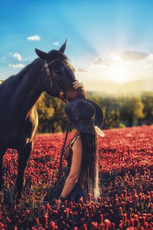 Portrait woman and horse outdoors. Woman hugging a horse.の写真素材