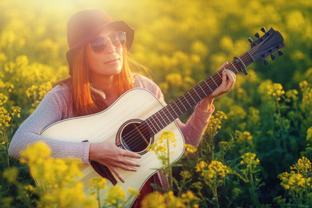 woman playing with guitar and blurred background.の写真素材