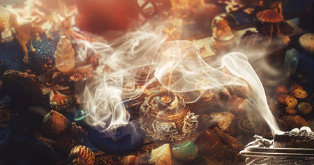 incense in a woman hand, incense smoke on a black background