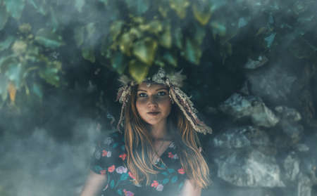 beautiful shamanic woman with headband in the nature.の写真素材