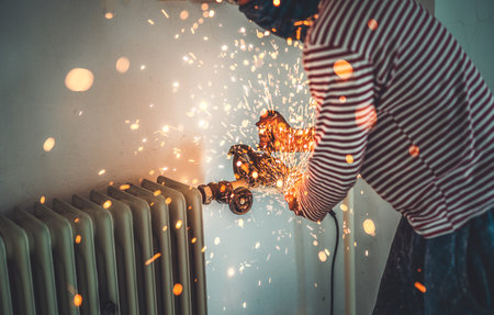 Worker cutting metal with grinder. Sparks while grinding iron.の写真素材