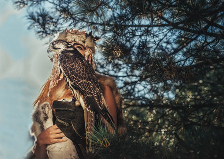 beautiful shamanic woman with eagle in the nature.