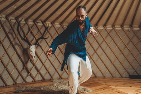 dancing warrior, ceremonial dance in a yurt.の写真素材