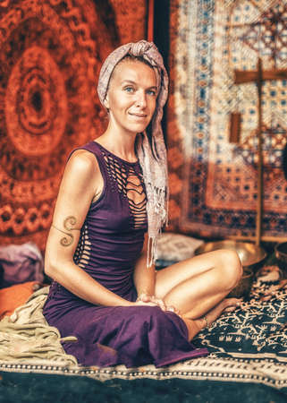 Spiritual girl sitting at Tibetan bowls.の写真素材