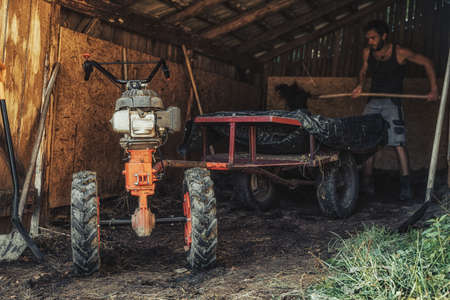man on a small tractor, farmer at work.の写真素材