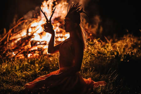 beautiful shamanic woman with headdress and deer skullの写真素材