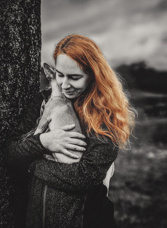 woman with a little dog in her arms.