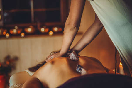 massage of a beautiful woman, body care.の写真素材