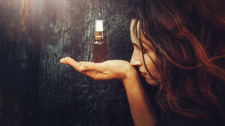 Beautiful woman and fragrance in hand.の写真素材