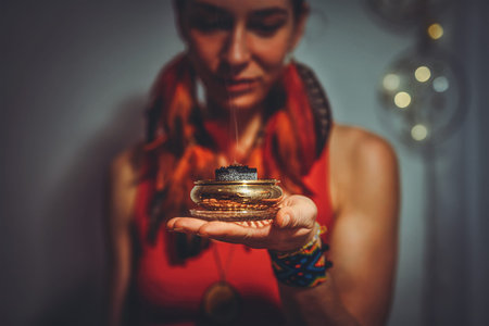 incense in a woman hand, ceremony space.の写真素材