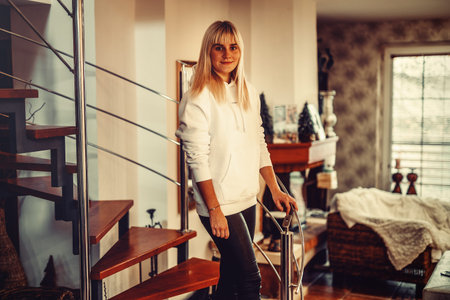 Young beautiful woman sitting on bed at home.の写真素材