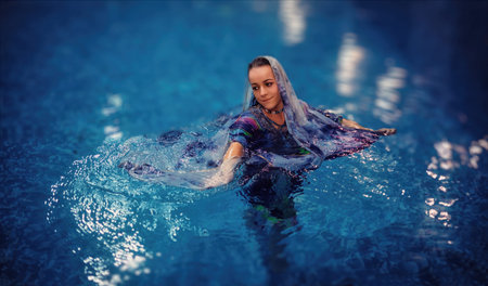 Pretty young woman relaxing in the pool.