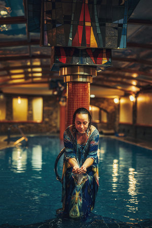 Pretty young woman relaxing in the pool.