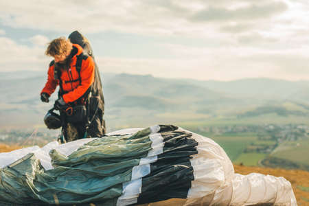 Paragliding in the mountains, paraglider on the ground.の写真素材