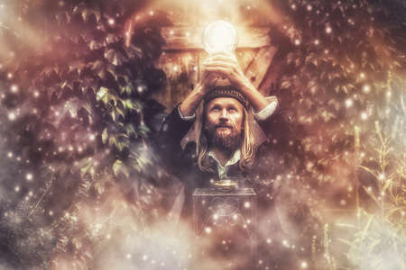 Alchemist in a beautiful ornamental dress in nature.の写真素材