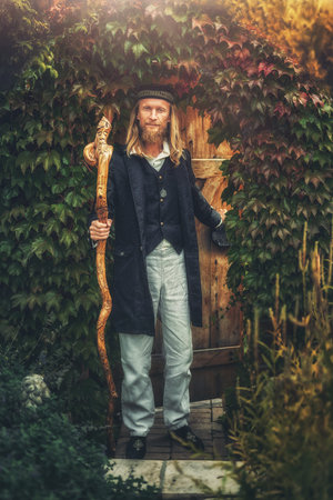 Alchemist in a beautiful ornamental dress in nature.の写真素材