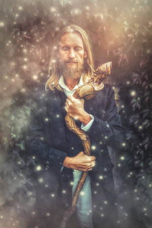 Alchemist in a beautiful ornamental dress in nature.の写真素材