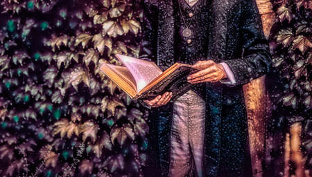 Alchemist in a beautiful ornamental dress in nature. Painting effect.の写真素材