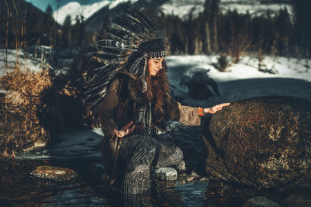 beautiful shamanic woman with headdress in the nature.の写真素材