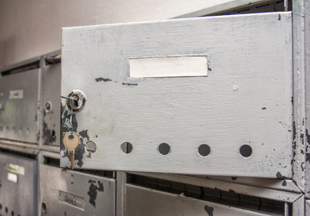 old open silver mailbox on the wall.