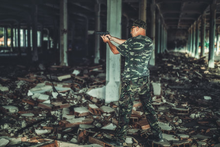 Airsoft hand in the hand industry building.の写真素材