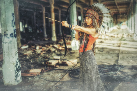 beautiful shamanic girl in the vintage industry building. Old photo effect.