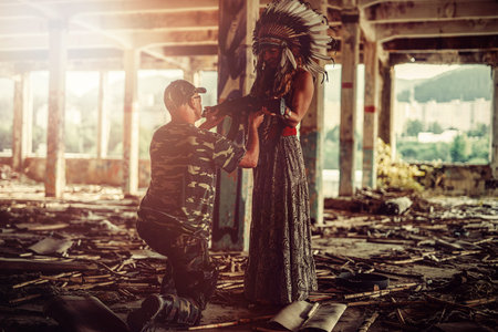 Airsoft soldier and indian woman in the old industry building.