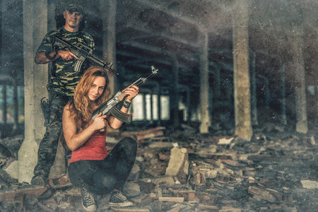 Airsoft sgrungeier in the grunge industry building. Old photo effect.
