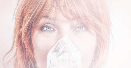 Woman face and crystal on crystal background.の写真素材