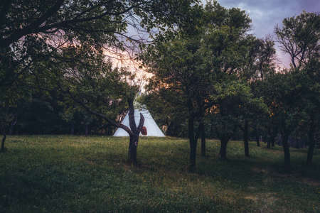 white teepee indian tent standing in beautiful landscape.の写真素材