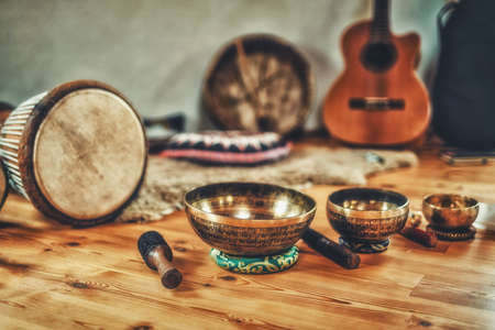 A still life of the shamanic drum and tibetan singing bowls.の写真素材