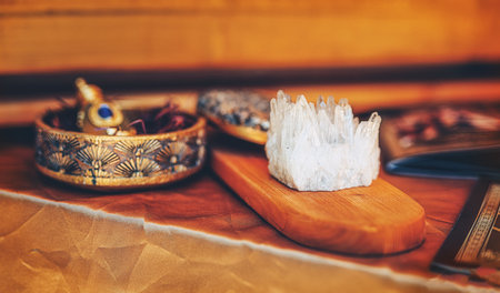 ornamental bottle of perfume and crystal on a wooden background.の写真素材